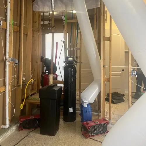 Photo shows Dryrite technicians at a job site setting up drying equipment to perform a water damage restoration